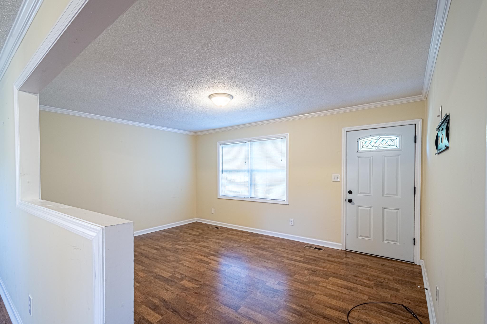 2294 Oak Grove Road Goodspring, TN 38460 - Photo 10 of 40 an empty room with wooden floor and window