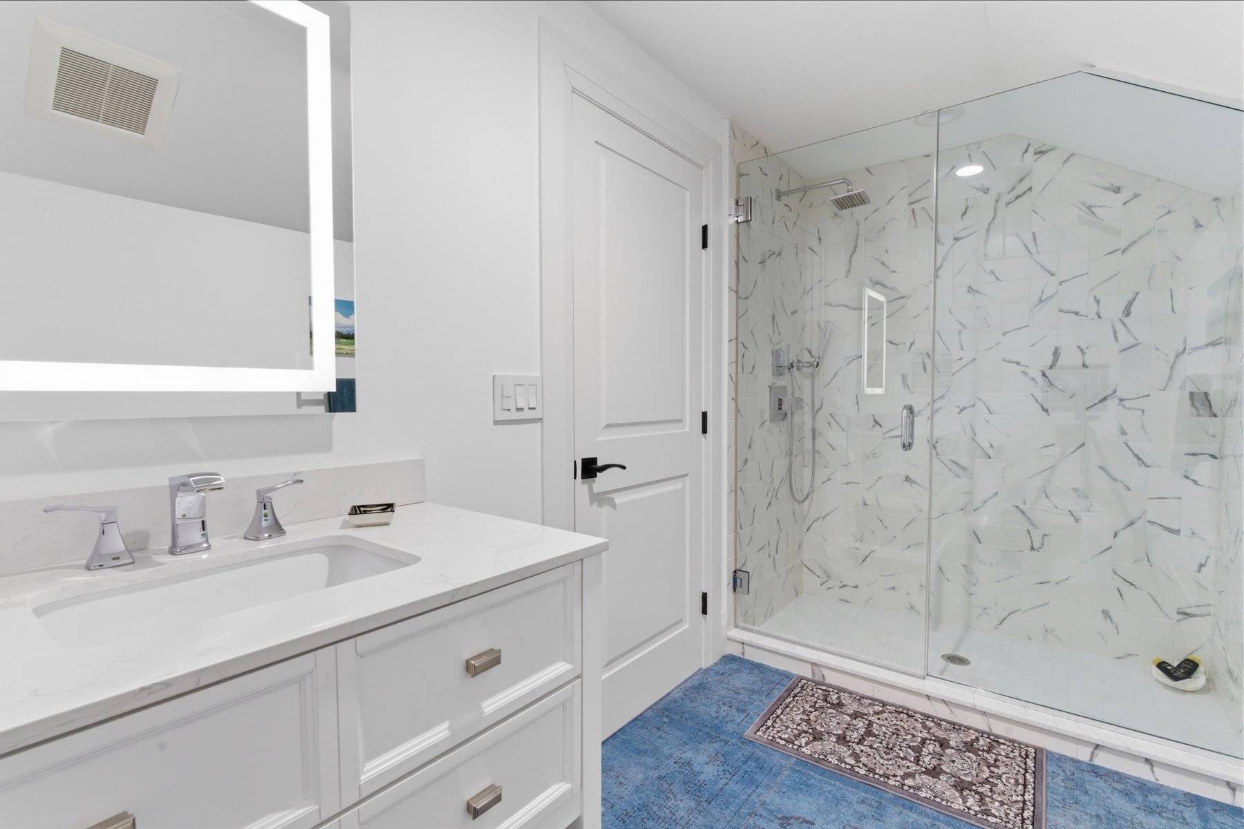 4 Post Lane Quogue, NY 11959 - Photo 35 of 42 a bathroom with a sink a mirror and shower