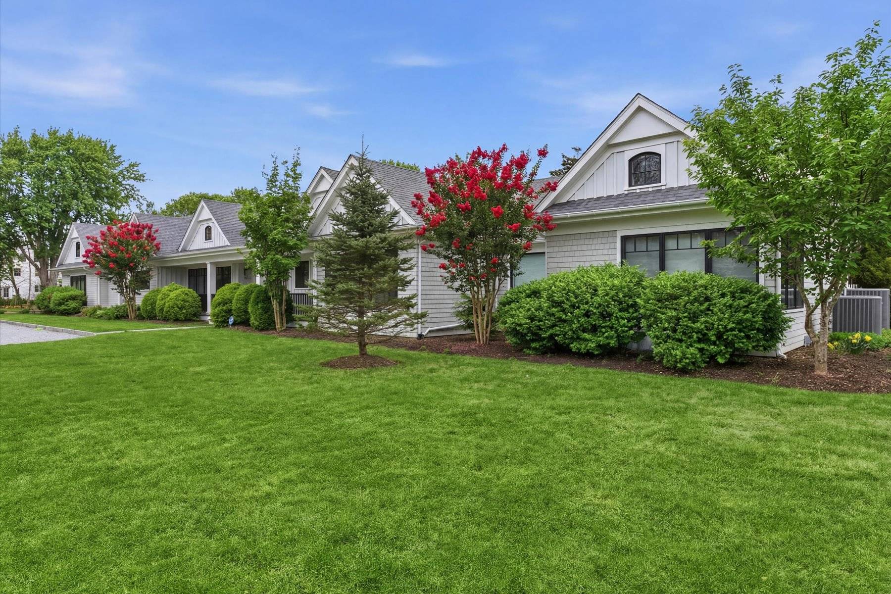 4 Post Lane Quogue, NY 11959 - Photo 4 of 42 a front view of a house with a garden