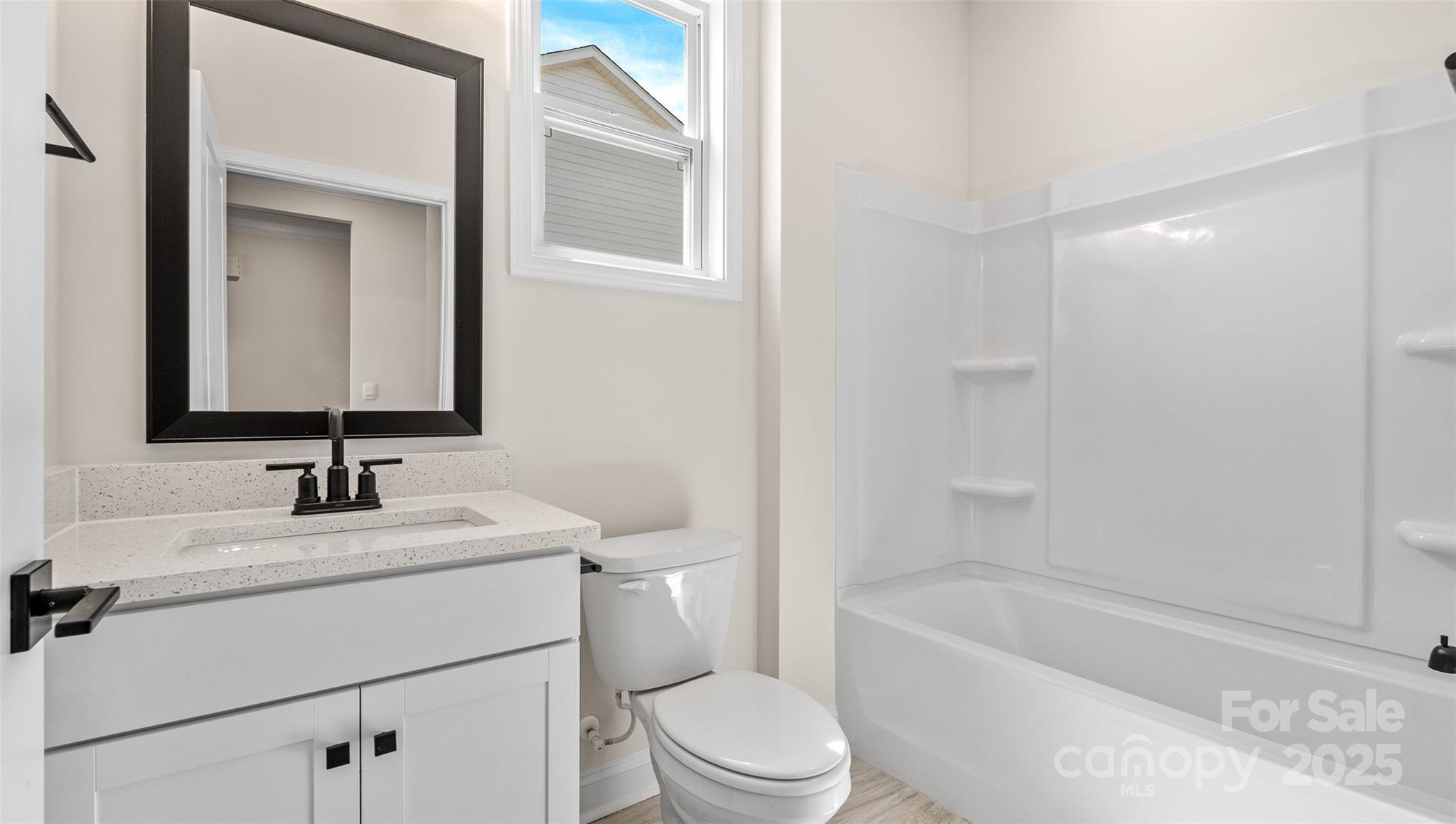 610 River Btm Road Fletcher, NC 28732 - Photo 21 of 28 a bathroom with a sink toilet vanity tub and shower