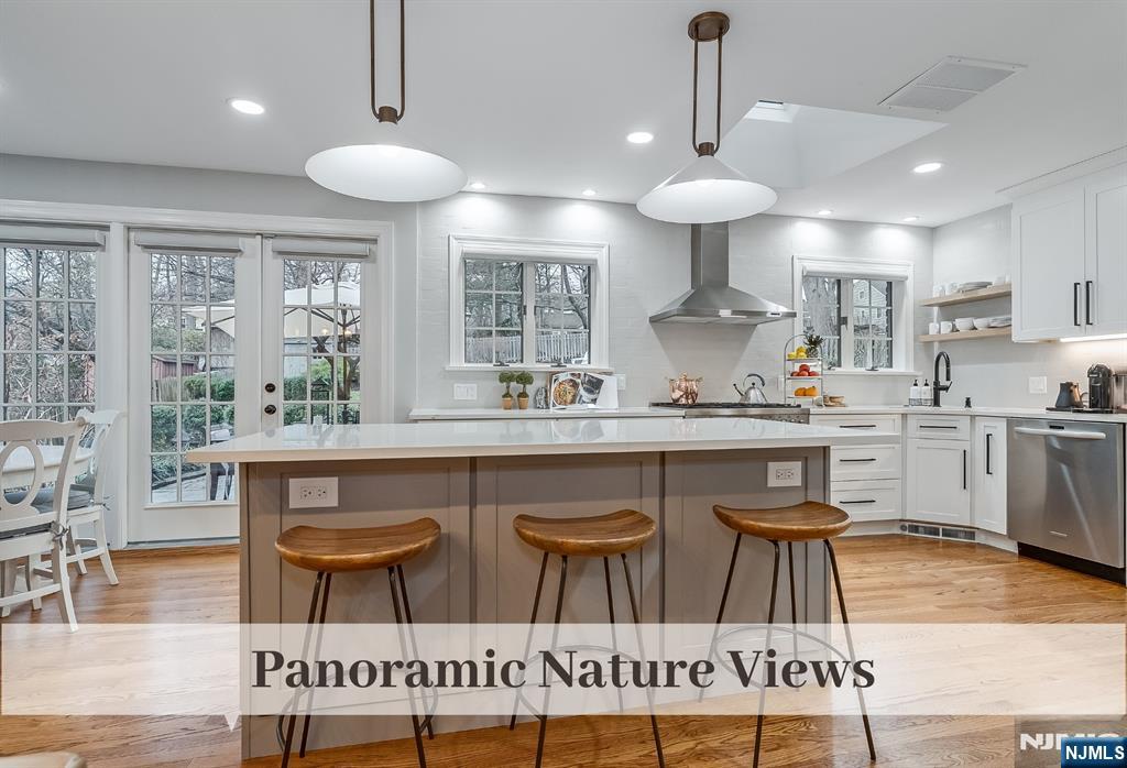 446 Upper Boulevard Ridgewood, NJ 07450 - Photo 11 of 48 a kitchen with stainless steel appliances granite countertop a stove a sink a oven a dining table and chairs