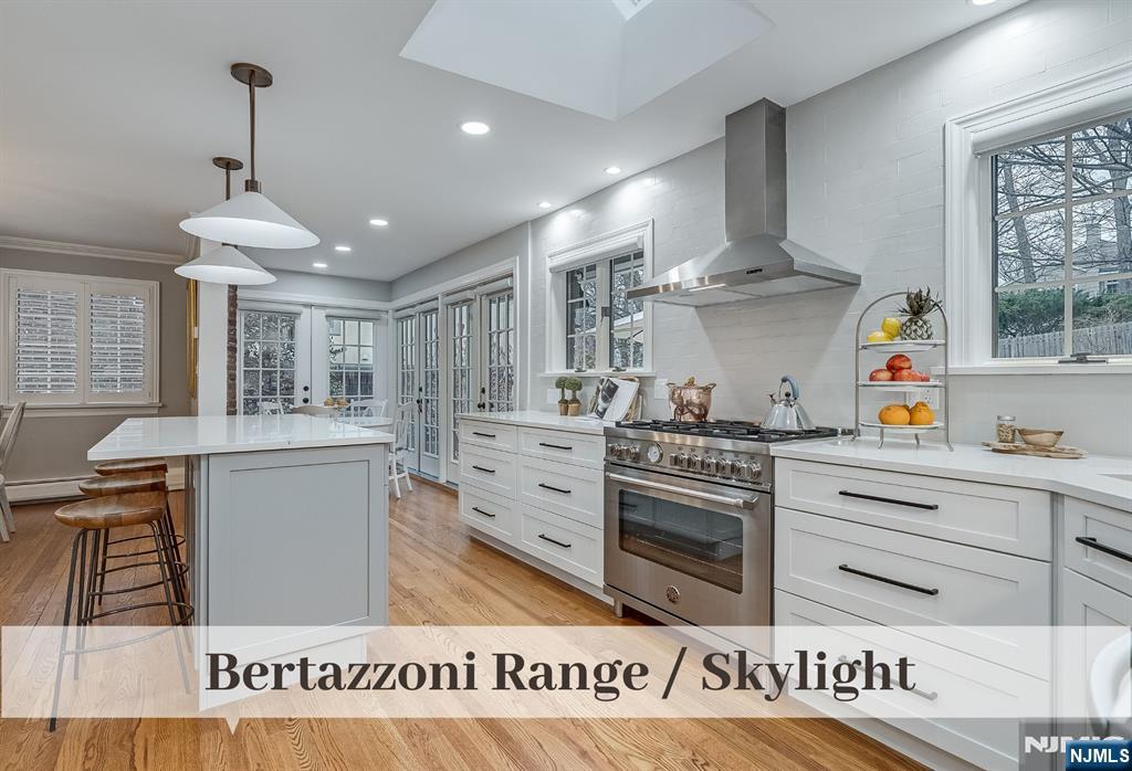 446 Upper Boulevard Ridgewood, NJ 07450 - Photo 13 of 48 a kitchen with stainless steel appliances granite countertop a stove a sink and a refrigerator