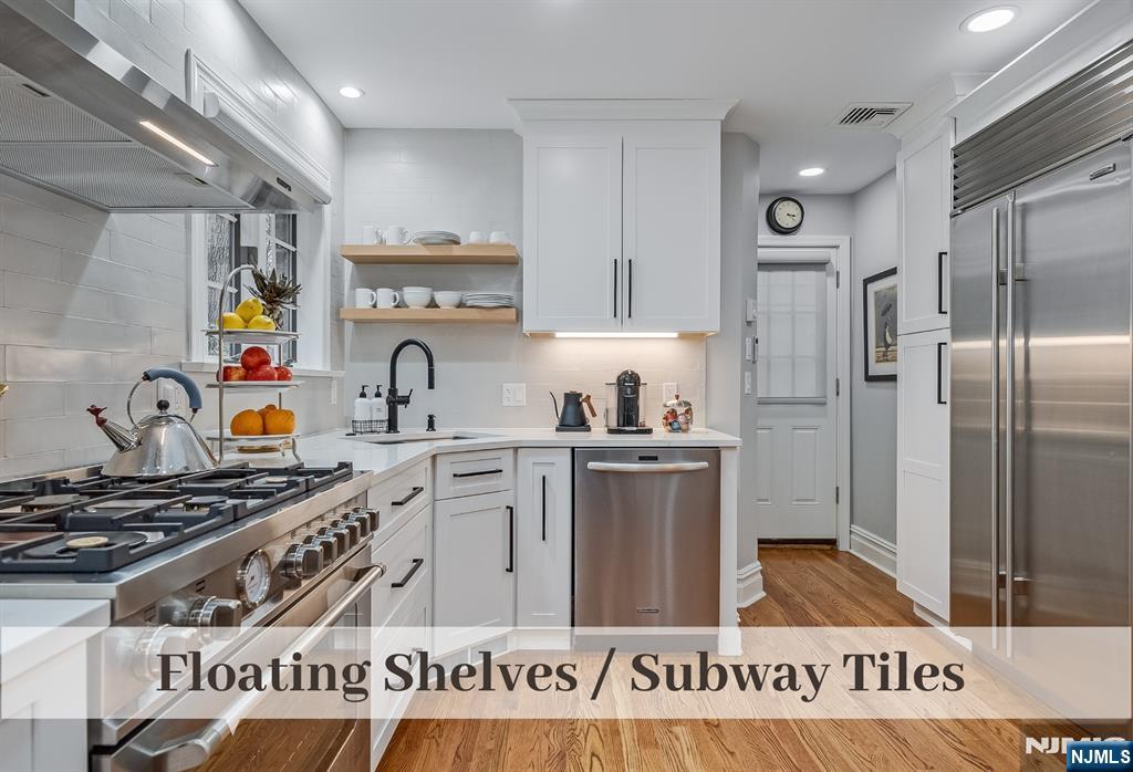 446 Upper Boulevard Ridgewood, NJ 07450 - Photo 14 of 48 a kitchen with stainless steel appliances granite countertop a sink stove and refrigerator