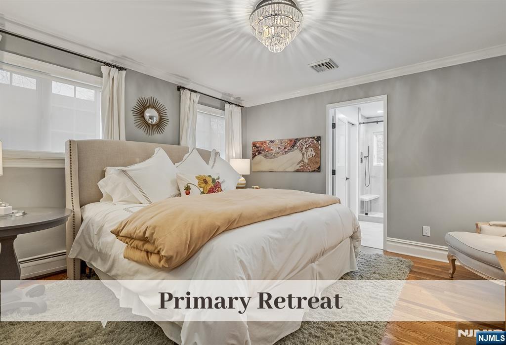 446 Upper Boulevard Ridgewood, NJ 07450 - Photo 21 of 48 a bedroom with a bed and a chandelier