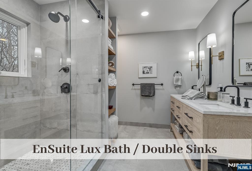 446 Upper Boulevard Ridgewood, NJ 07450 - Photo 22 of 48 a bathroom with a shower a sink and a mirror