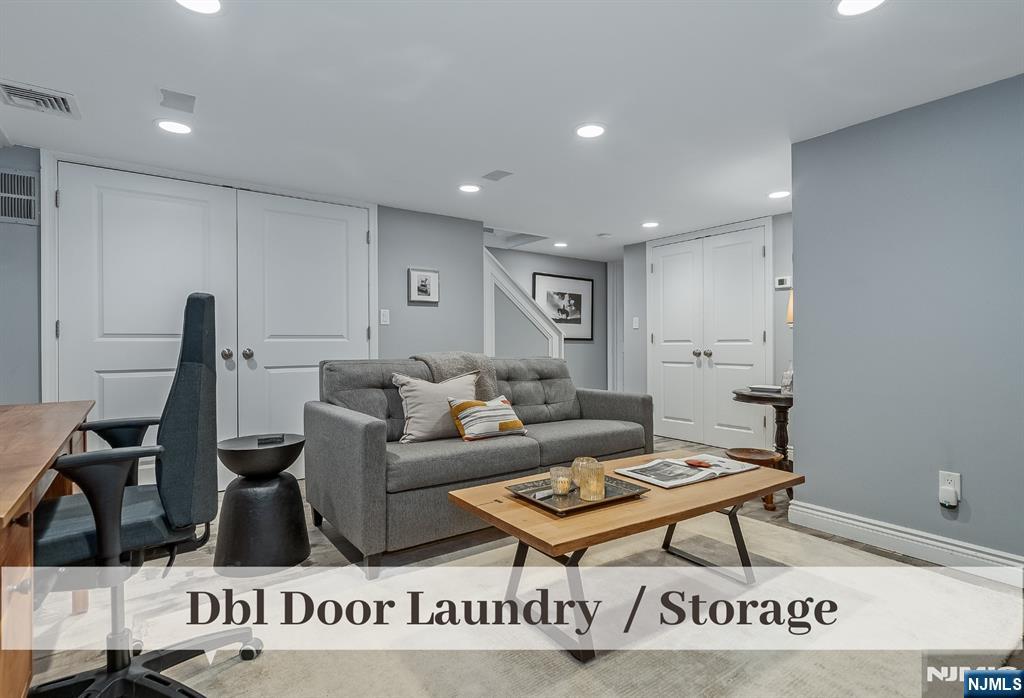 446 Upper Boulevard Ridgewood, NJ 07450 - Photo 34 of 48 a living room with furniture a rug and a projector