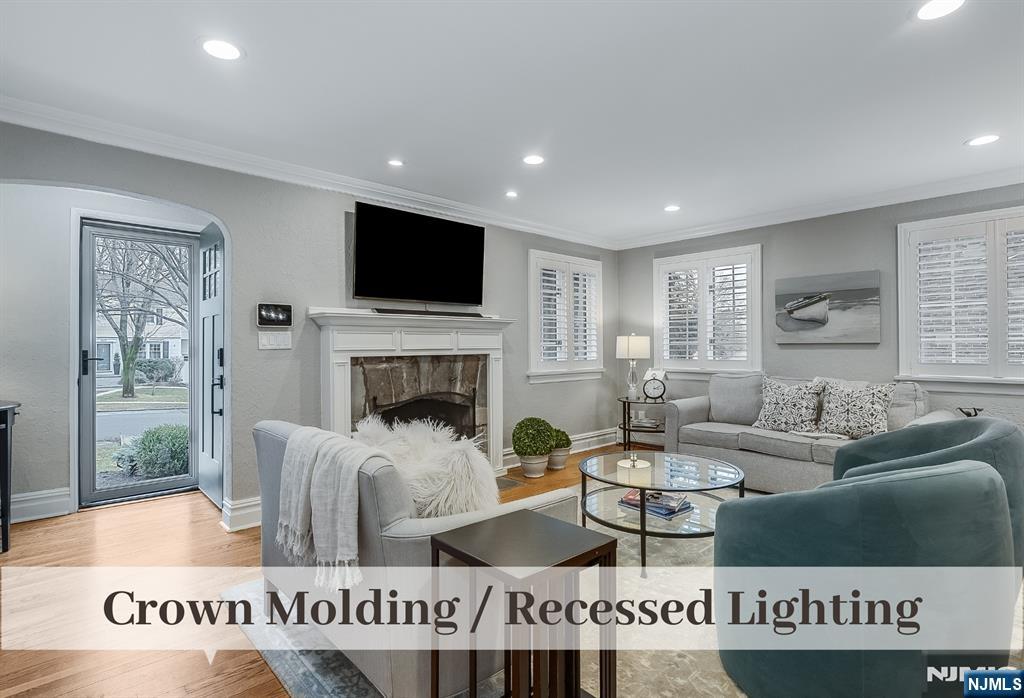 446 Upper Boulevard Ridgewood, NJ 07450 - Photo 5 of 48 a living room with furniture a flat screen tv and a fireplace