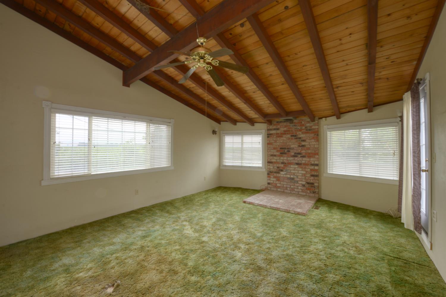 2931 East Marshall Road Patterson, CA 95363 - Photo 23 of 54 Master bedroom with Wood Bean ceiling and ceiling fan. Brick area for Wood Stove