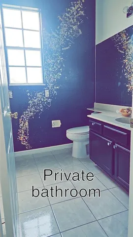 a bathroom with a sink a toilet and window