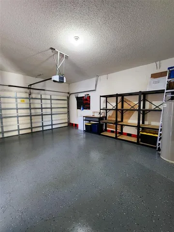 a view of a kitchen with stainless steel appliances granite countertop a stove and a large window