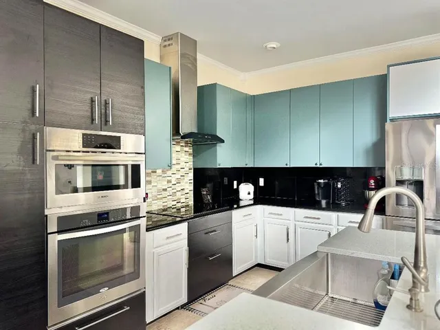 a kitchen with a sink and white cabinets