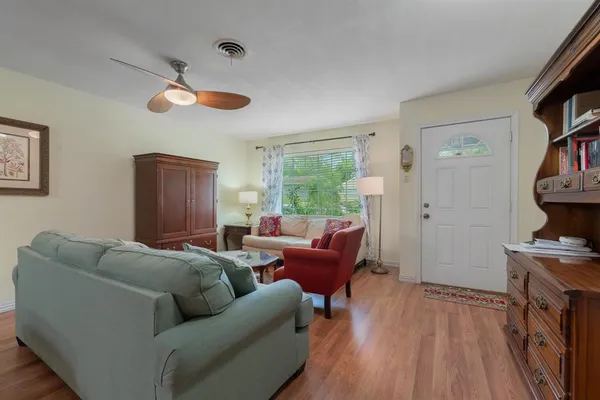 a living room with furniture a fireplace and a window