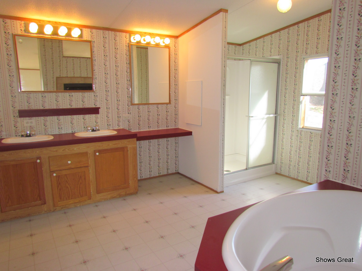 4714 Wade Road Roanoke, VA 24018 - Photo 6 of 16 a spacious bathroom with a double vanity sink and a mirror