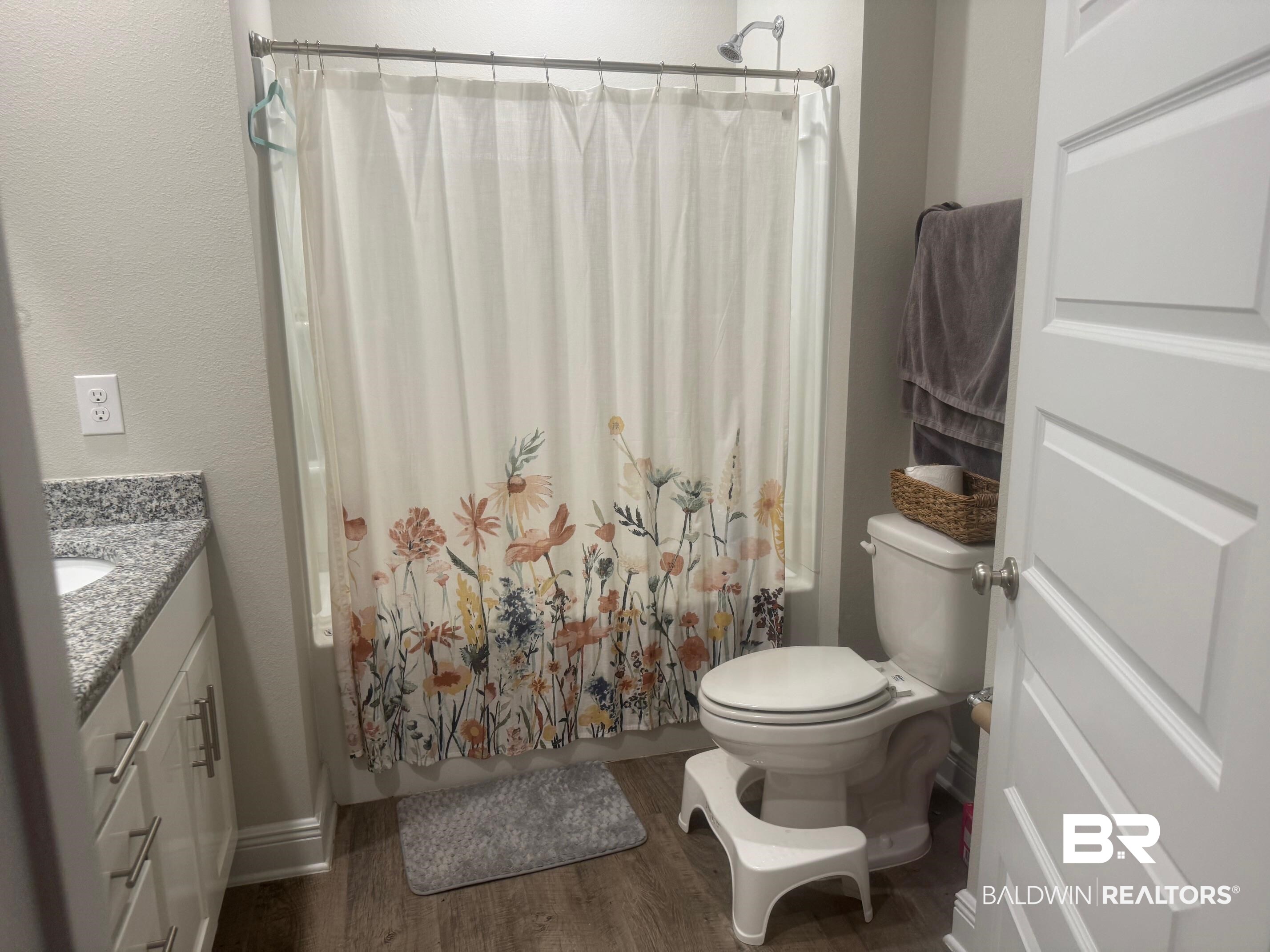 24903 Spectacular Bid Loop Daphne, AL 36526 - Photo 28 of 37 Bathroom with vanity, wood finished floors, and shower / tub combo