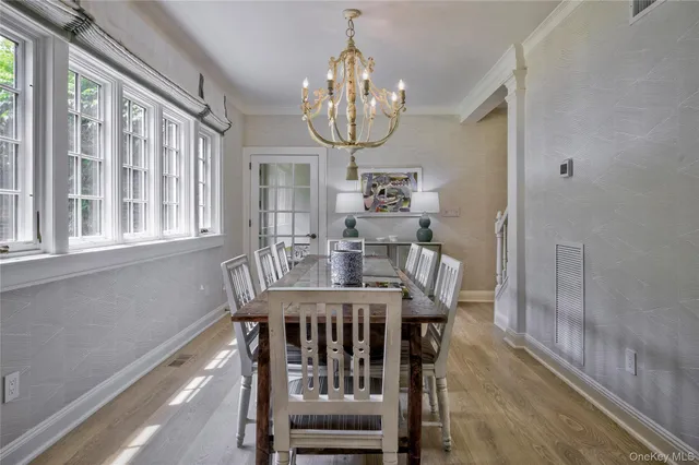 a view of a dining room with furniture wooden floor and chandelier