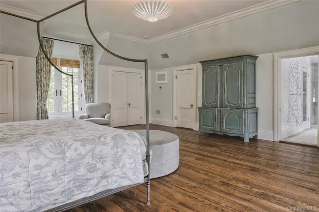 a spacious bedroom with a bed and a mirror