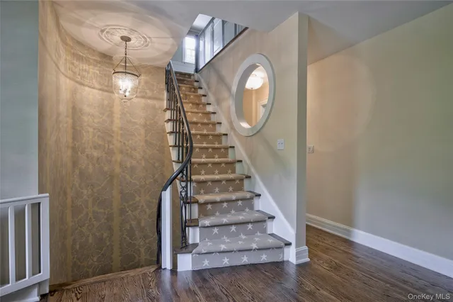 a view of entryway and hall with wooden floor