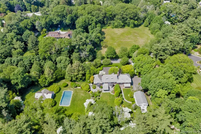 an aerial view of residential house with an outdoor space and seating