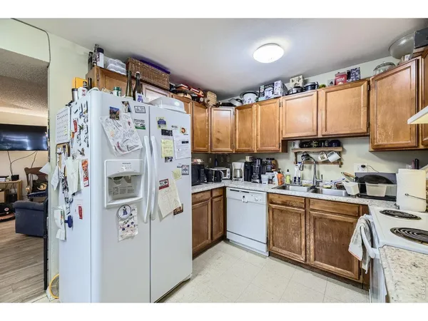 a kitchen with refrigerator and cabinets