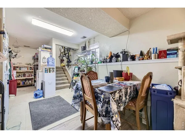 a kitchen with stainless steel appliances kitchen island granite countertop a refrigerator oven a sink dishwasher and white cabinets with wooden floor