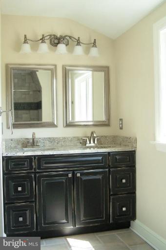 1039 Corbett Road Monkton, MD 21111 - Photo 14 of 22 a bathroom with a granite countertop sink and a mirror