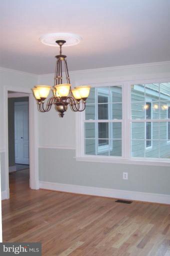 1039 Corbett Road Monkton, MD 21111 - Photo 3 of 22 a view of an empty room with window and wooden floor