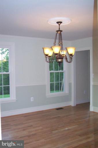 1039 Corbett Road Monkton, MD 21111 - Photo 4 of 22 a dining room with wooden floor chandelier and entryway