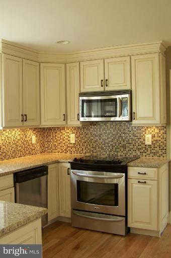1039 Corbett Road Monkton, MD 21111 - Photo 5 of 22 a kitchen with granite countertop white cabinets stainless steel appliances and sink