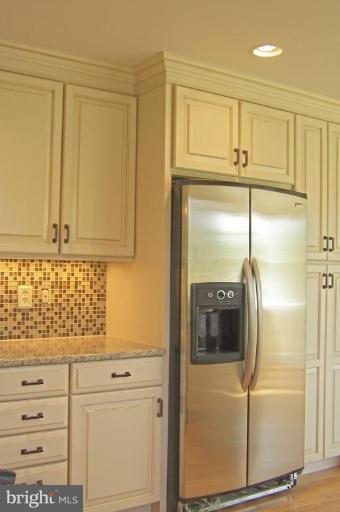 1039 Corbett Road Monkton, MD 21111 - Photo 7 of 22 a kitchen with white cabinets and stainless steel appliances