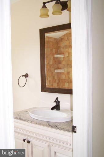 1039 Corbett Road Monkton, MD 21111 - Photo 10 of 22 a bathroom with a granite countertop sink and a mirror