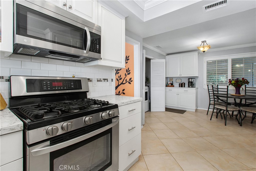 1451 Trenton Drive Riverside, CA 92506 - Photo 17 of 41 The kitchen has the same oversized ceramic tile from the entry and hallway. This room was completely rennovated in 2019.