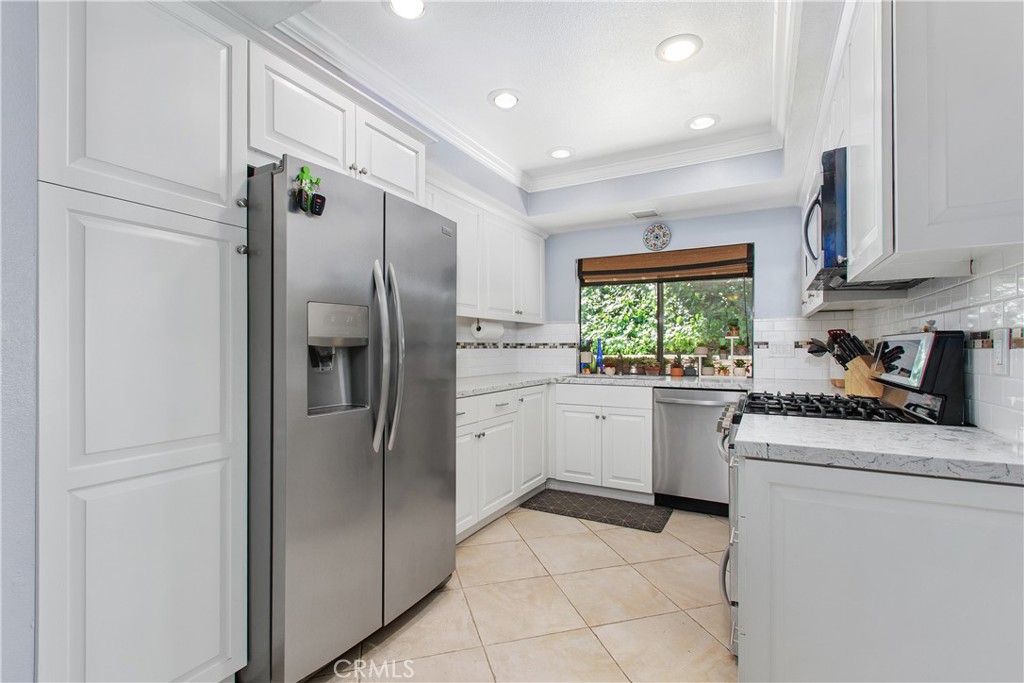 1451 Trenton Drive Riverside, CA 92506 - Photo 20 of 41 Large storage cabinets have pull out drawers for pantry storage.