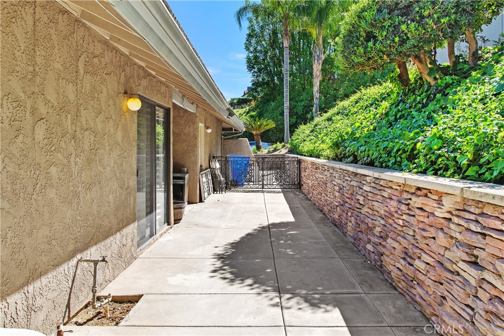 1451 Trenton Drive Riverside, CA 92506 - Photo 36 of 41 This is the side yard which has the sliding door access from the dining room. The gate leads to the front driveway.