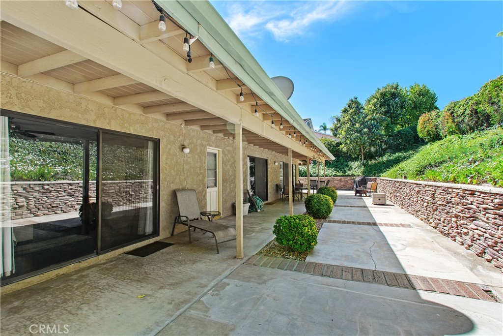 1451 Trenton Drive Riverside, CA 92506 - Photo 37 of 41 The primary bedroom end of the patio, looking toward the family and living room doors.