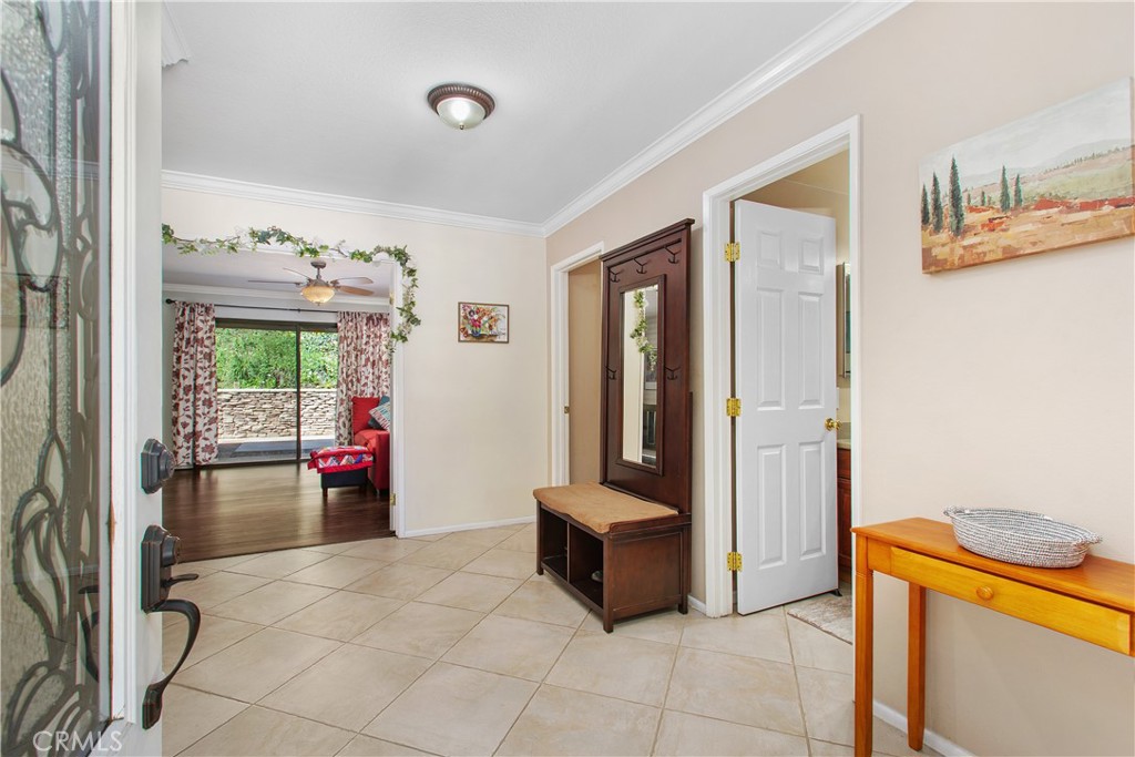 1451 Trenton Drive Riverside, CA 92506 - Photo 6 of 41 Welcome Home! The entry foyer has oversize ceramic tile, crown molding, and the guest 1/2 bath to the left.