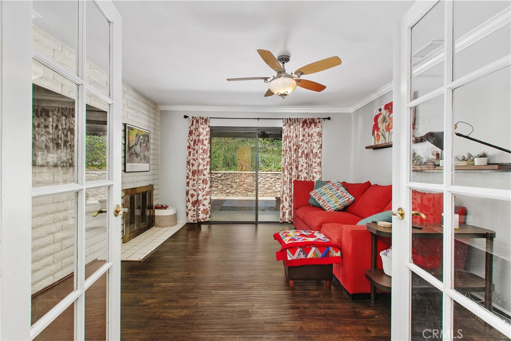1451 Trenton Drive Riverside, CA 92506 - Photo 8 of 41 The family room is a cozy space to enjoy movies with the family. Notice the fireplace, and sliding door to the back patio.