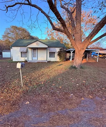 a front view of house with yard and trees