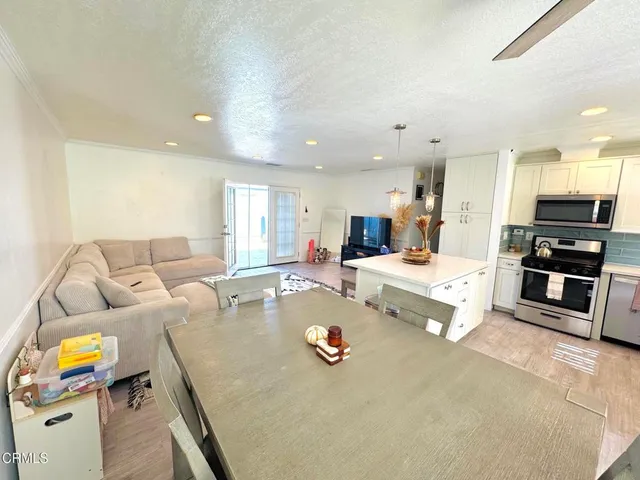 a living room with furniture and kitchen view