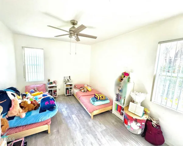 a bedroom with toys and a window