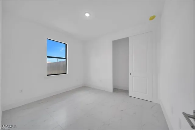 a bathroom with a toilet sink vanity and mirror
