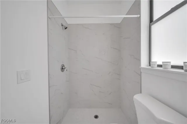 a bathroom with a sink toilet vanity and a mirror