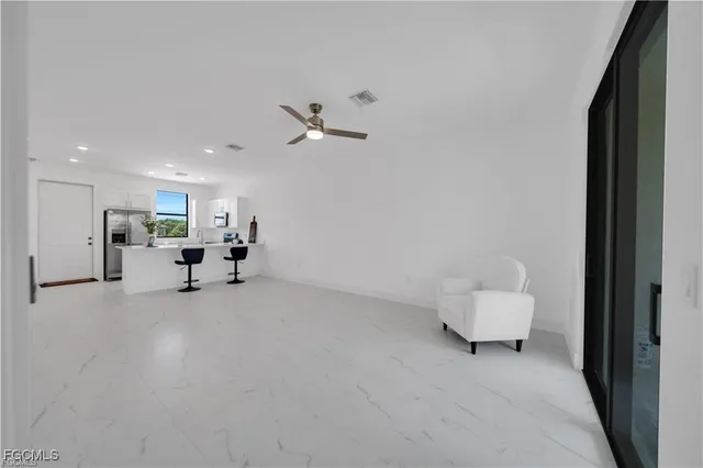 a view of a livingroom with furniture and a chandelier fan