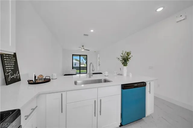 a kitchen with sink and cabinets