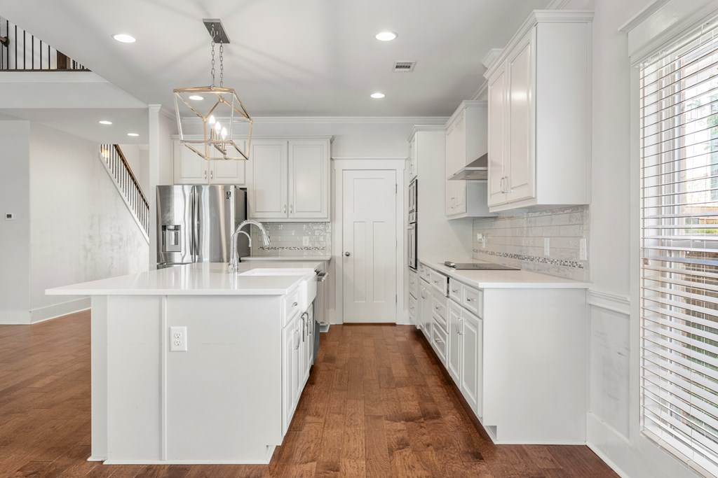 7044 Spring Walk Drive Columbus, GA 31904 - Photo 14 of 41 a kitchen with kitchen island granite countertop a sink a counter space appliances and cabinets