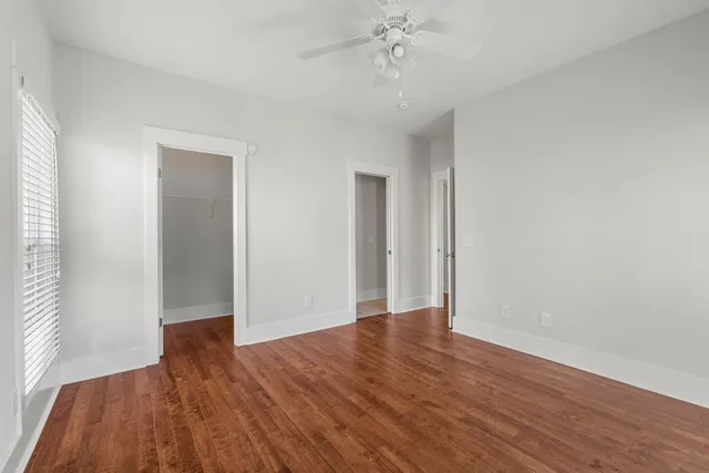 wooden floor in an empty room with a window