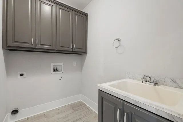 a bathroom with a sink and cabinets
