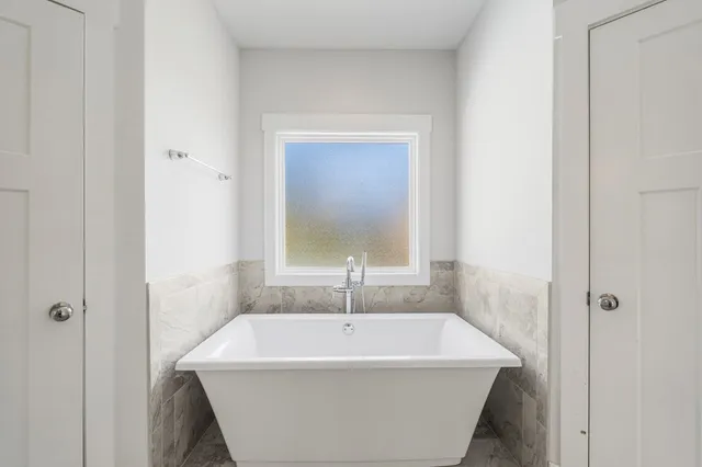 a white bath tub sitting in a bathroom