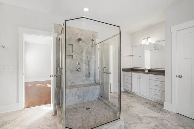 a bathroom with a shower and a sink