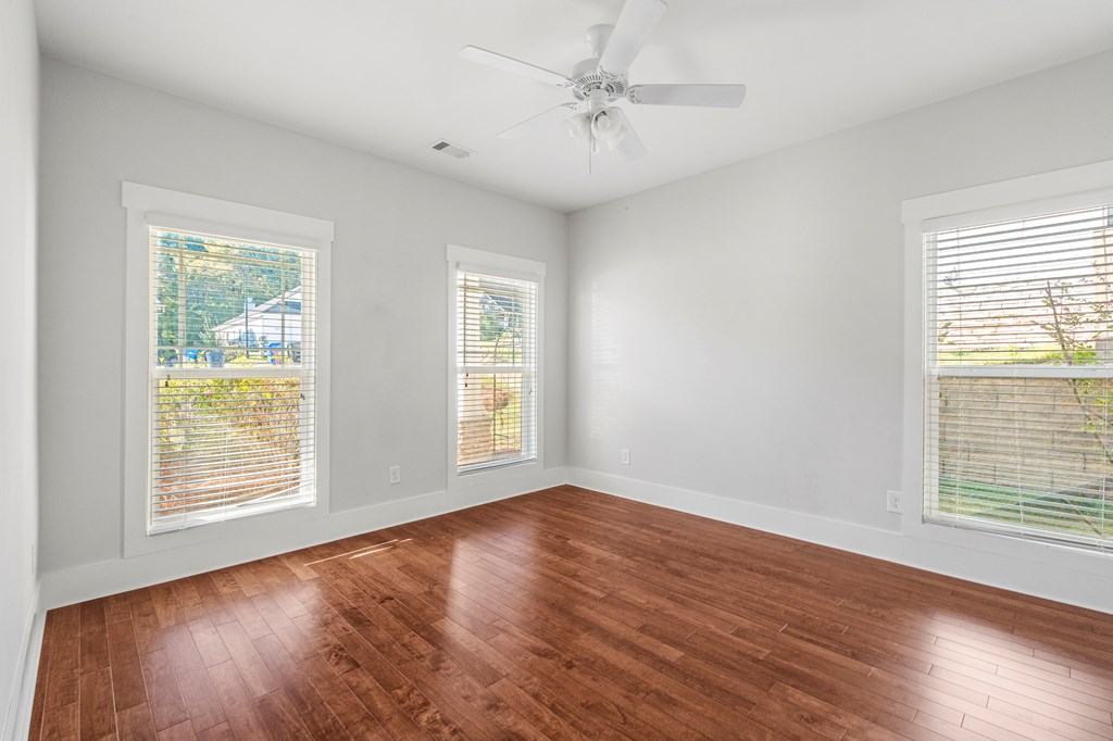7044 Spring Walk Drive Columbus, GA 31904 - Photo 6 of 41 a view of an empty room with wooden floor and a window