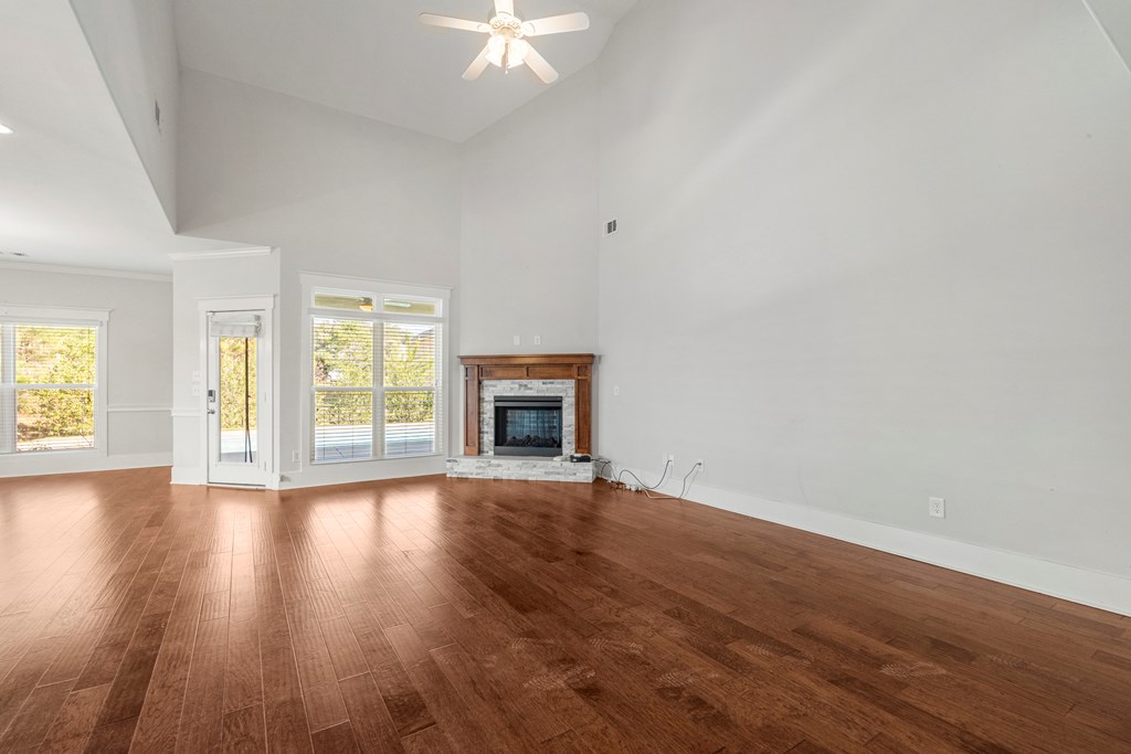 7044 Spring Walk Drive Columbus, GA 31904 - Photo 7 of 41 an empty room with wooden floor fireplace and windows